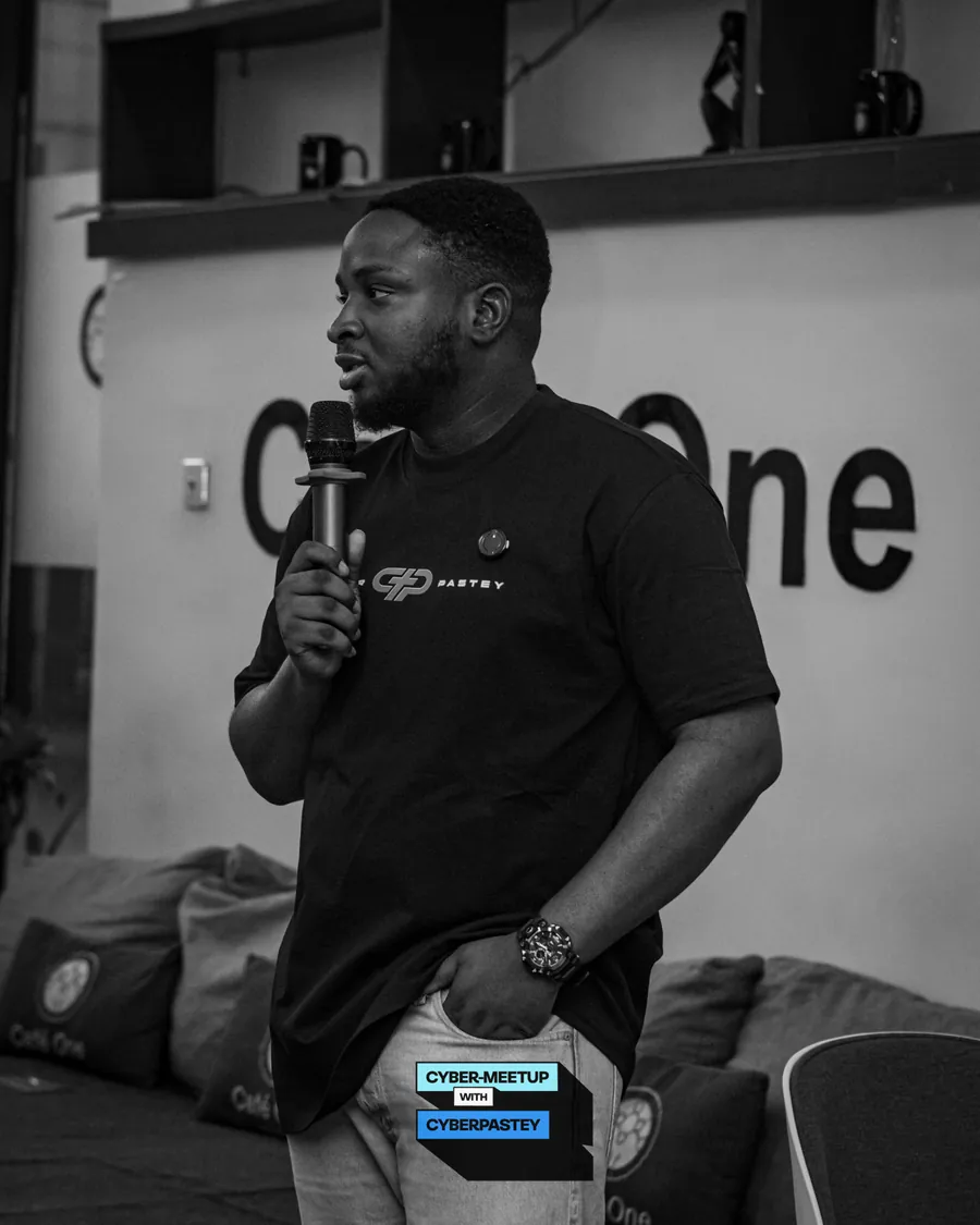 CyberPastey convener speaking with a microphone at Café One