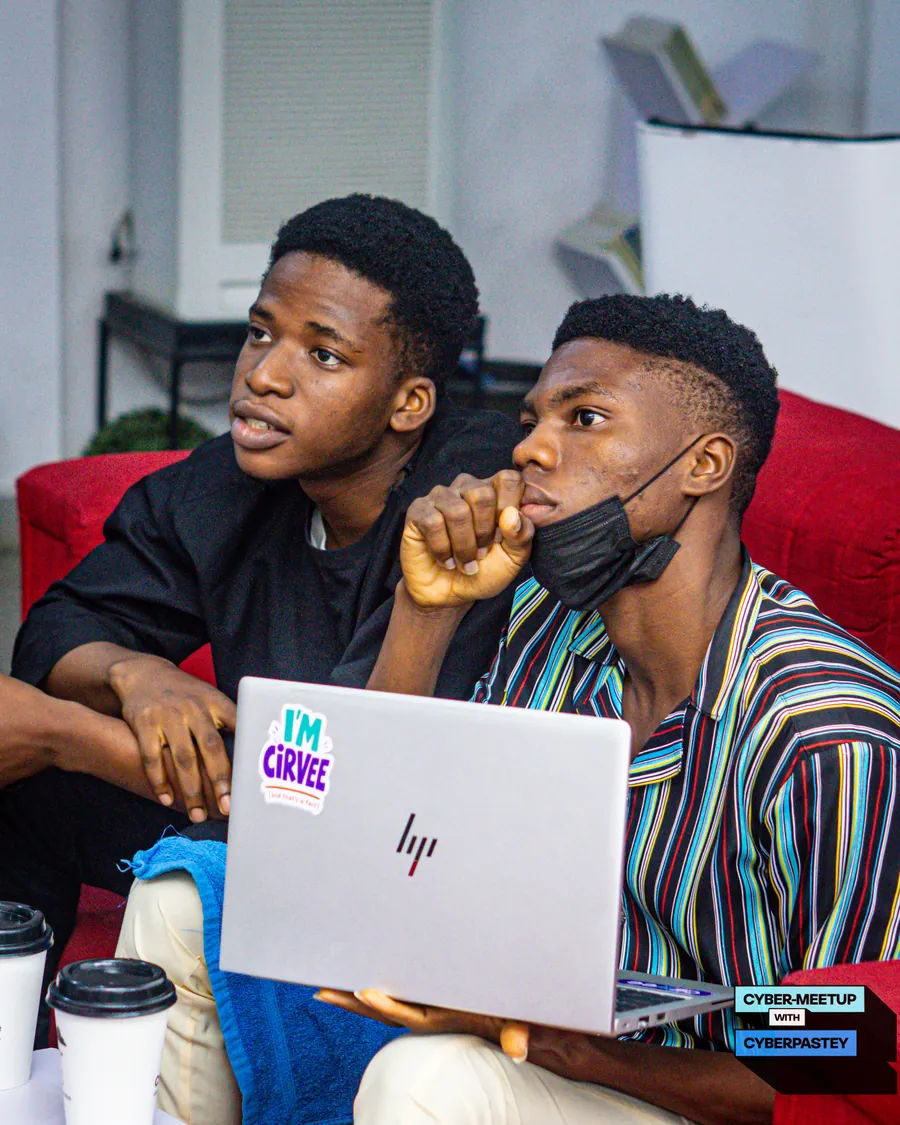 Two attendees listening closely during a Cyber Meetup session